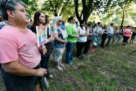 Volunteers hold photos of the 49 people killed Sunday in the Orlando nightclub shooting during a Thursday memorial service at Bergfeld Park in Tyler. A single bell tolled and the line of volunteers grew as each name was read, followed by a brief biography in the person and their age. Andrew D. Brosig/Tyler Morning Telegraph